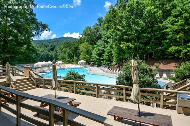 1115 Wild Turkey Blf, Jasper, GA 30143 - community pool featuring outdoor dining space, a deck, and a forest view