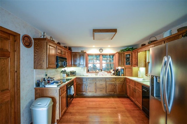 1115 Wild Turkey Blf, Jasper, GA 30143 - kitchen featuring black appliances, light wood-type flooring, light countertops, and brown cabinets