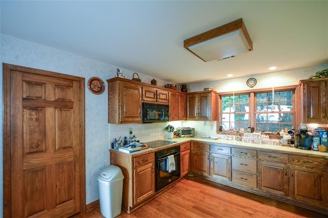 1115 Wild Turkey Blf, Jasper, GA 30143 - kitchen with black appliances, brown cabinets, light countertops, light wood-style flooring, and tasteful backsplash