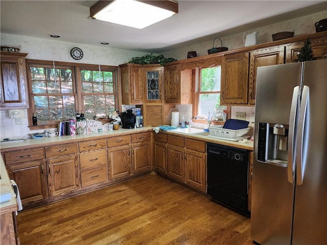 1115 Wild Turkey Blf, Jasper, GA 30143 - kitchen featuring stainless steel fridge with ice dispenser, black dishwasher, a sink, brown cabinets, and light wood-type flooring