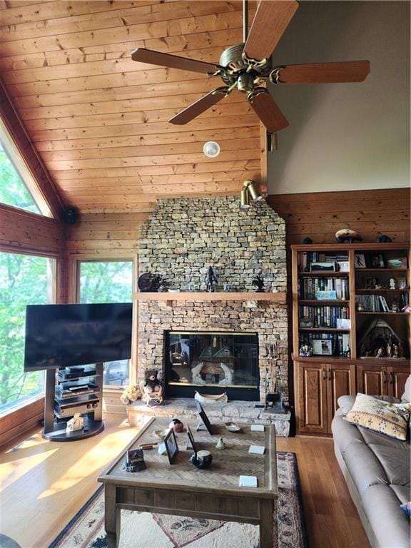 1115 Wild Turkey Blf, Jasper, GA 30143 - living room featuring healthy amount of natural light, wood finished floors, a ceiling fan, high vaulted ceiling, and a stone fireplace