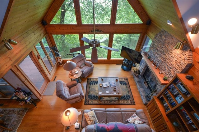 1115 Wild Turkey Blf, Jasper, GA 30143 - living room with high vaulted ceiling, plenty of natural light, wood finished floors, and a stone fireplace