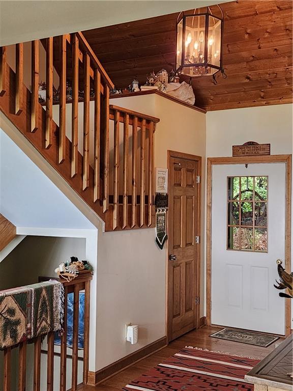 1115 Wild Turkey Blf, Jasper, GA 30143 - entrance foyer featuring wooden ceiling, a chandelier, baseboards, and stairs