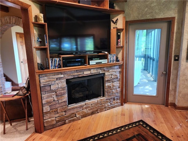 1115 Wild Turkey Blf, Jasper, GA 30143 - living room featuring wood-type flooring and a stone fireplace