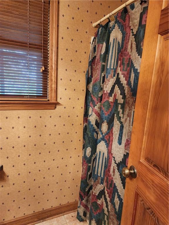 1115 Wild Turkey Blf, Jasper, GA 30143 - full bathroom featuring wallpapered walls, baseboards, and a shower with curtain