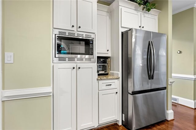 370 Fairleaf Ct, Alpharetta, GA 30022 - kitchen featuring stainless steel appliances, dark wood-style floors, white cabinetry, light stone countertops, and ornamental molding