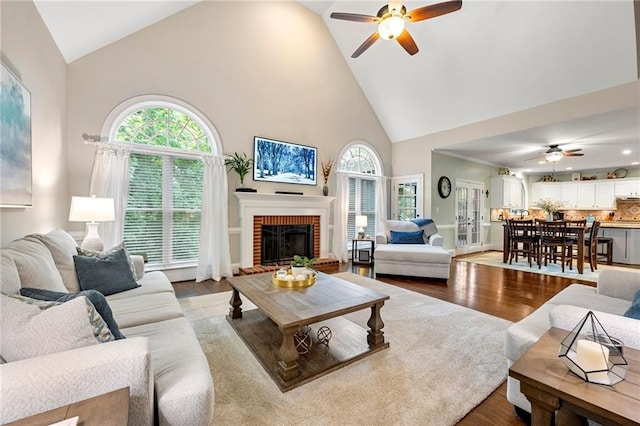 370 Fairleaf Ct, Alpharetta, GA 30022 - living room featuring a ceiling fan, high vaulted ceiling, plenty of natural light, a brick fireplace, and dark wood-style floors