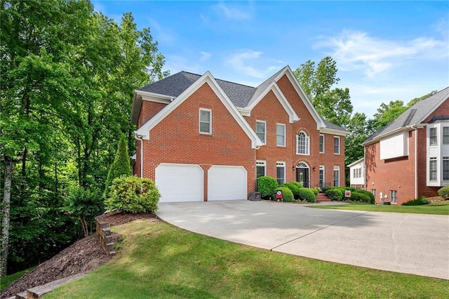 370 Fairleaf Ct, Alpharetta, GA 30022 - view of front of house with brick siding, driveway, an attached garage, a front lawn, and roof with shingles