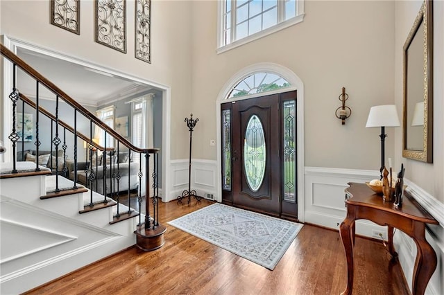 370 Fairleaf Ct, Alpharetta, GA 30022 - entryway featuring a wainscoted wall, stairway, wood finished floors, a decorative wall, and a high ceiling