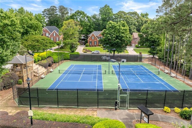 370 Fairleaf Ct, Alpharetta, GA 30022 - view of tennis court with fence and view of scattered trees