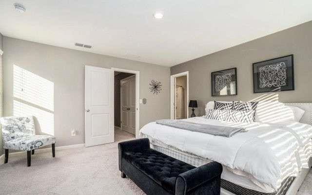 bedroom with light colored carpet, visible vents, and baseboards