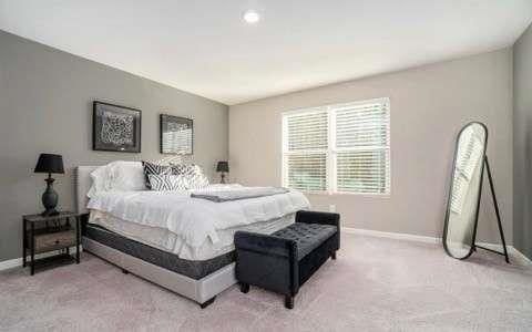 bedroom featuring baseboards and light colored carpet