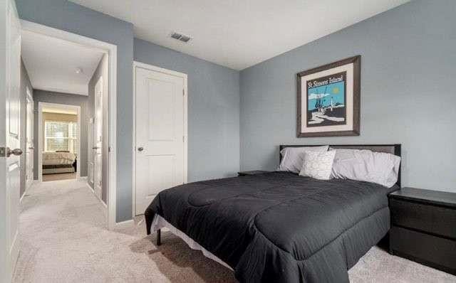 bedroom featuring light colored carpet