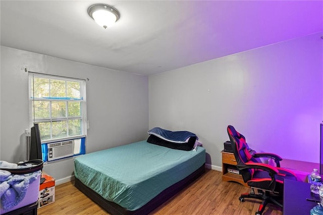 bedroom featuring hardwood / wood-style floors and cooling unit