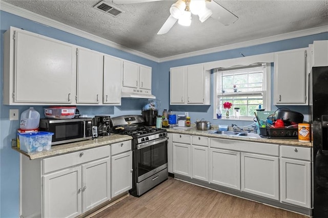 kitchen with white cabinets, sink, crown molding, and stainless steel appliances