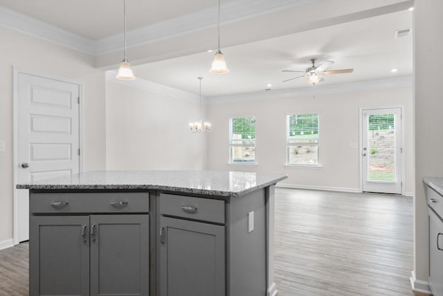 kitchen featuring visible vents, light wood-style flooring, gray cabinetry, and ornamental molding