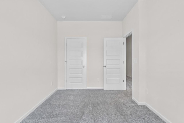 unfurnished bedroom with carpet and baseboards