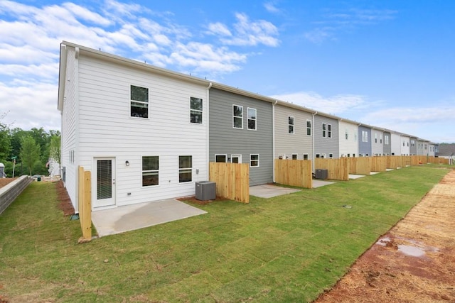 back of house with a yard, a patio, cooling unit, and fence