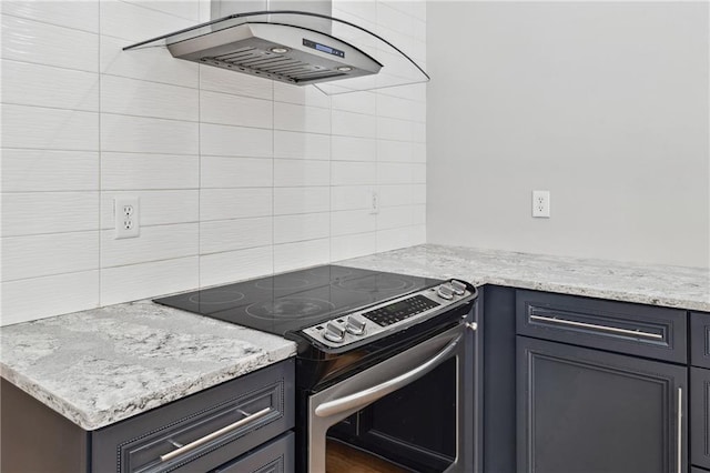 1755 Pinetree Pass Ln SW, Lilburn, GA 30047 - kitchen with light stone counters, stainless steel electric range oven, exhaust hood, and backsplash