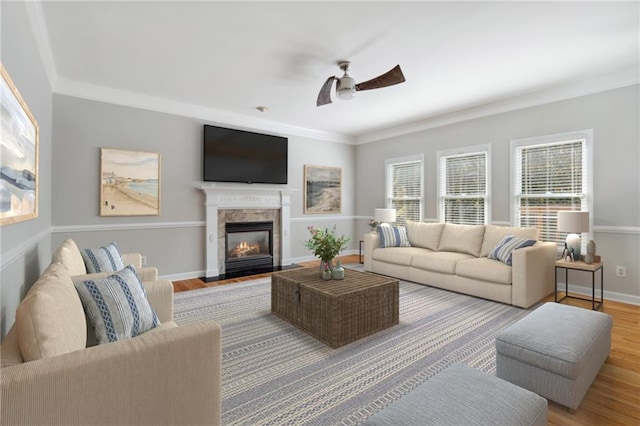 1755 Pinetree Pass Ln SW, Lilburn, GA 30047 - living area featuring baseboards, a ceiling fan, crown molding, a fireplace with flush hearth, and wood finished floors