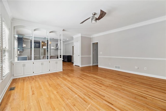 1755 Pinetree Pass Ln SW, Lilburn, GA 30047 - unfurnished living room featuring crown molding, visible vents, ceiling fan, and light wood-type flooring