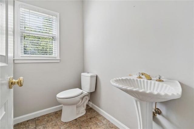 1755 Pinetree Pass Ln SW, Lilburn, GA 30047 - half bathroom featuring toilet and baseboards
