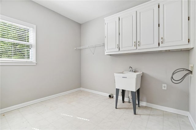 1755 Pinetree Pass Ln SW, Lilburn, GA 30047 - washroom featuring washer hookup, baseboards, cabinet space, and light floors