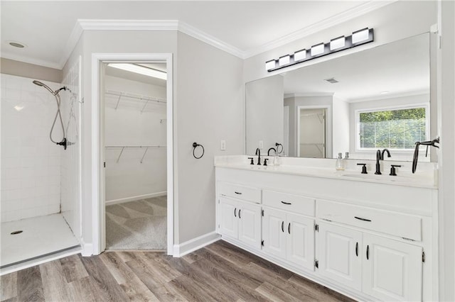 1755 Pinetree Pass Ln SW, Lilburn, GA 30047 - full bathroom featuring a sink, double vanity, crown molding, a tile shower, and wood finished floors