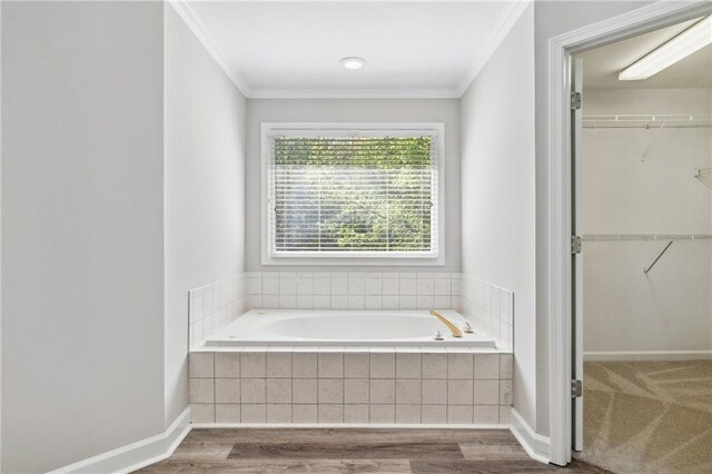 1755 Pinetree Pass Ln SW, Lilburn, GA 30047 - full bathroom featuring a spacious closet, ornamental molding, a bath, and wood finished floors