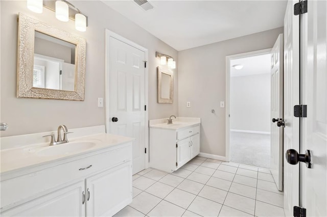 1755 Pinetree Pass Ln SW, Lilburn, GA 30047 - bathroom with tile patterned floors, visible vents, a sink, and two vanities