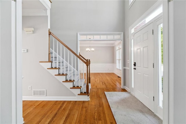 1755 Pinetree Pass Ln SW, Lilburn, GA 30047 - foyer with a high ceiling, crown molding, stairs, visible vents, and wood finished floors