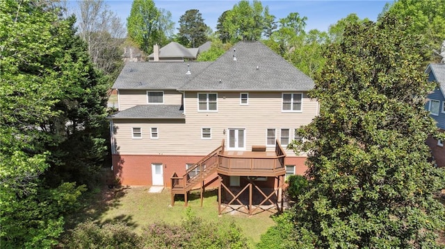 1755 Pinetree Pass Ln SW, Lilburn, GA 30047 - back of property with a yard, roof with shingles, a wooden deck, and stairs