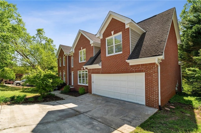 1755 Pinetree Pass Ln SW, Lilburn, GA 30047 - view of front of home with roof with shingles, concrete driveway, a garage, and brick siding
