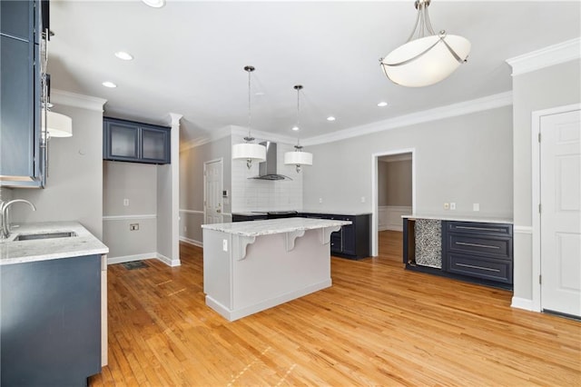 1755 Pinetree Pass Ln SW, Lilburn, GA 30047 - kitchen featuring wall chimney exhaust hood, a sink, crown molding, light wood finished floors, and a breakfast bar area