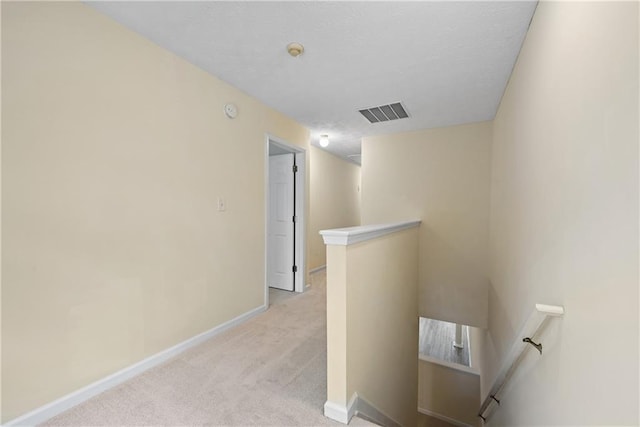 2991 Greyhawk Ln, Cumming, GA 30040 - hallway with visible vents, baseboards, an upstairs landing, a textured ceiling, and light carpet