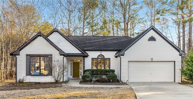 view of front of property with a front yard and a garage