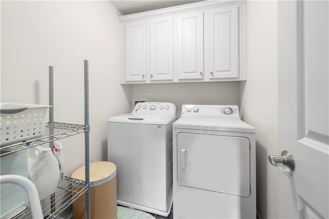 washroom with cabinets and washing machine and dryer