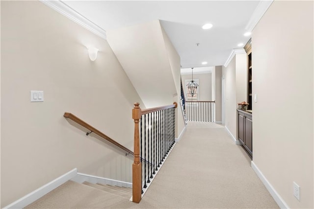 staircase featuring carpet flooring, an inviting chandelier, and crown molding