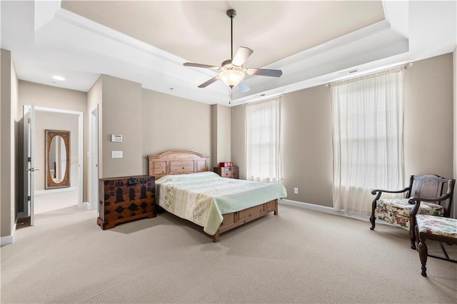 bedroom featuring a tray ceiling, ceiling fan, and light colored carpet