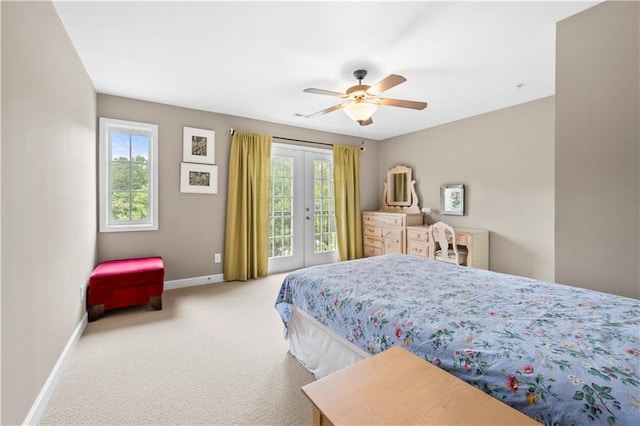 carpeted bedroom featuring ceiling fan, french doors, access to outside, and multiple windows