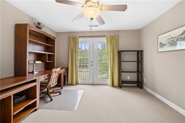 carpeted office space with french doors and ceiling fan