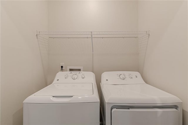 clothes washing area with independent washer and dryer