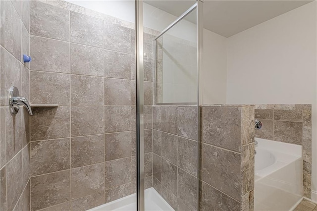 bathroom featuring shower with separate bathtub