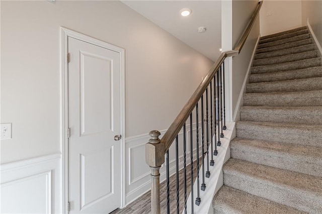 stairway featuring wood-type flooring