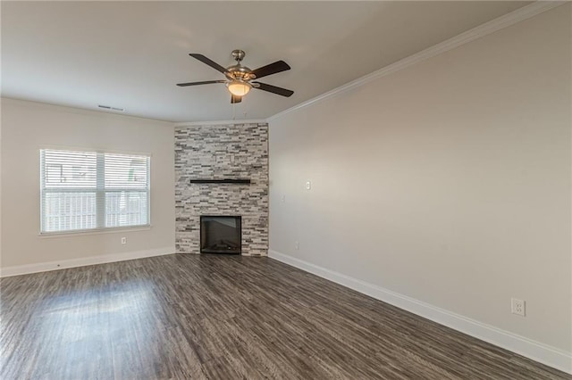 unfurnished living room featuring crown molding, dark wood-type flooring, ceiling fan, and a fireplace