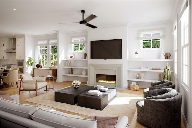 living room featuring light hardwood / wood-style floors, ornamental molding, a healthy amount of sunlight, and ceiling fan