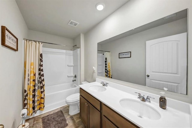 full bathroom featuring vanity, toilet, and shower / tub combo