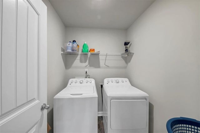 clothes washing area with washer and dryer