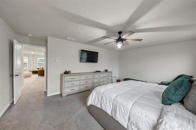 bedroom featuring light colored carpet and ceiling fan