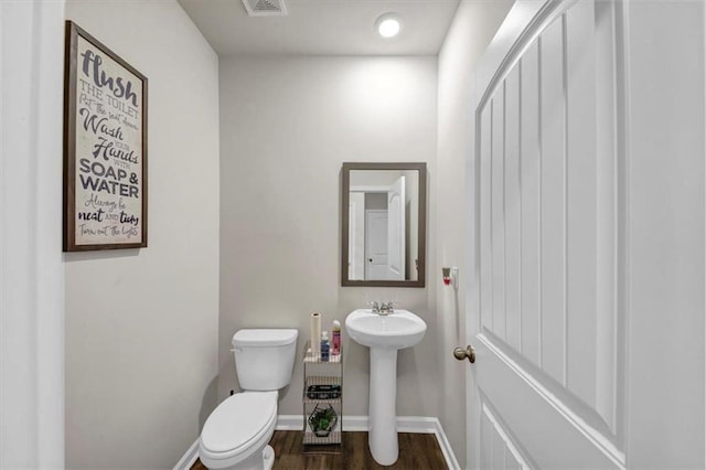 bathroom with sink, hardwood / wood-style flooring, and toilet